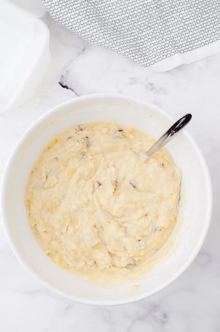 Stir the wet and dry ingredients together in a large mixing bowl for a moist buttermilk banana bread recipe.