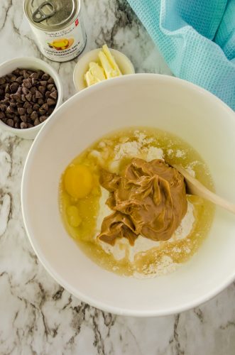 cake mix, egg, and peanut butter in a mixing bowl for peanut butter fudge bars