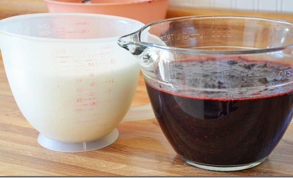 equal parts of mashed blackberries and sugar measured out and sitting side by side