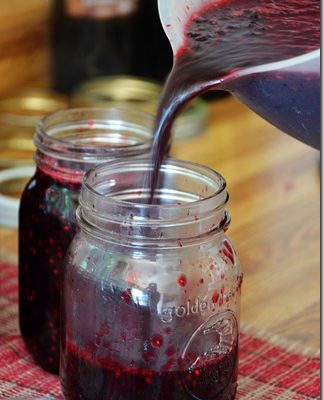 blackberry jam being poured into jars