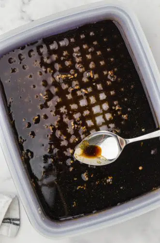chicken teriakyi marinade being stirred in a tupperware marinade container