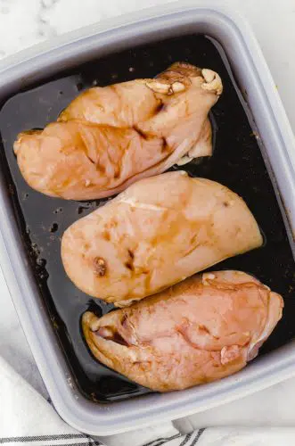 Chicken breasts sitting in teriakyi chicken marinade