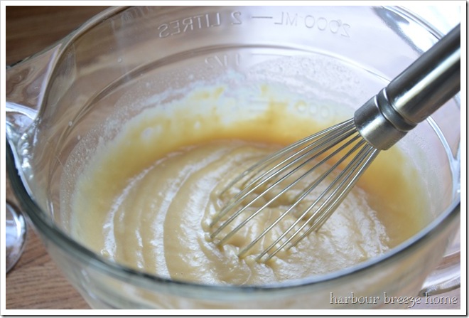 homemade vanilla pudding that has been cooked in the microwave in a bowl with a whisk in it.