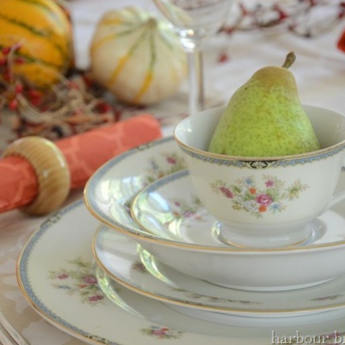 A real pear in a china teacup as part of a fall table setting