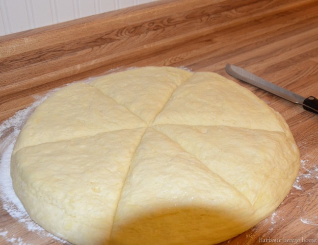 overnight buns being cut before they are formed into crescent rolls
