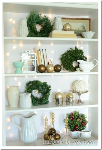 christmas bookcase with twinkles at harbourbreezehome.com
