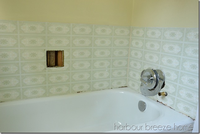 fake tile (also known as barker board) in a bathroom above a tub