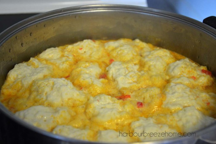 Drop dumplings on the top of potato soup in a large pot