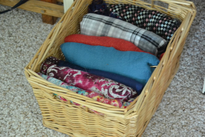 Scarves folded neatly in a basket. /5 Simple Ways to Organize a Small Master Bedroom at harbourbreezehome.com
