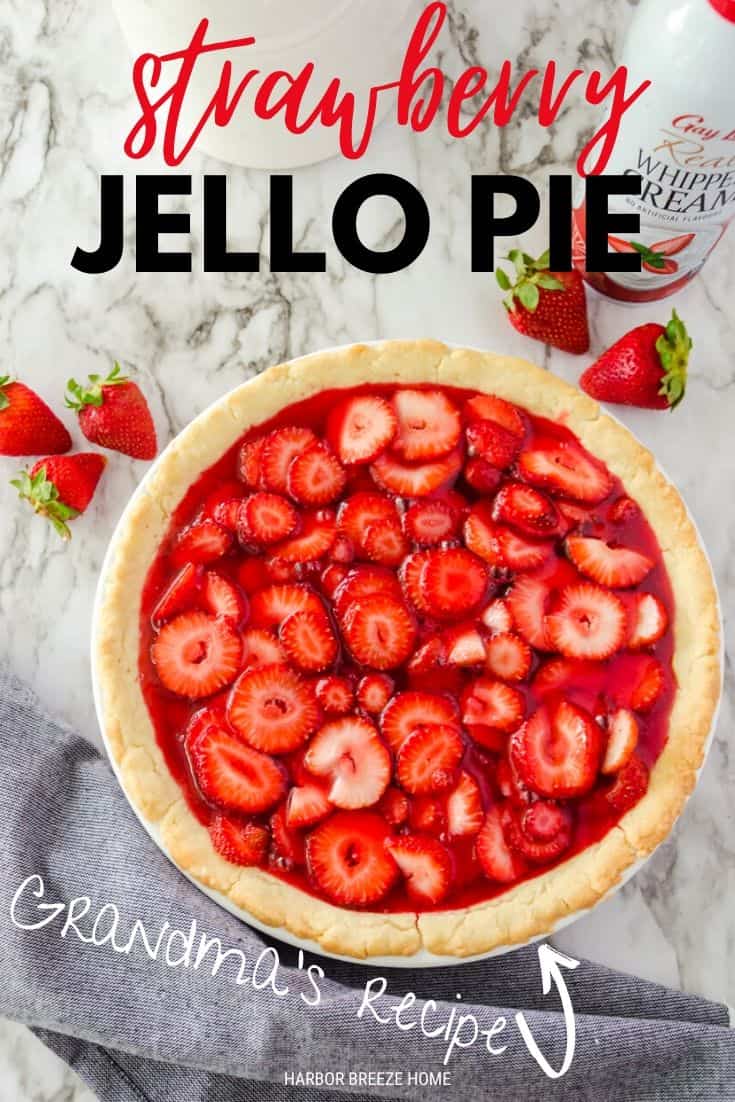 Picture of whole strawberry pie with jello with strawberries around it.
