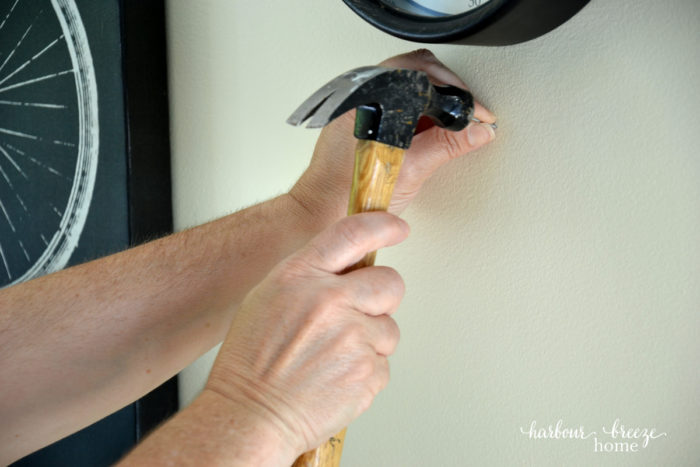 How to hang pictures on the wall: Are you paralyzed from hanging pictures on the wall for fear you'll put a nail in the wrong place? If so, this life hack will rock your socks off! Learn how to quickly and simply hang pictures in exactly the place you want using simple tools around the house. Click to read the easiest method ever! how to hang a picture on the wall