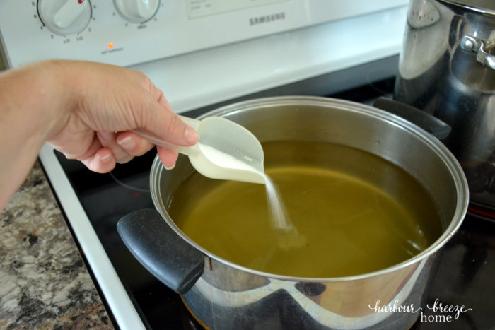 How to make apple juice - sugar being added to homemade apple juice in a stockpot