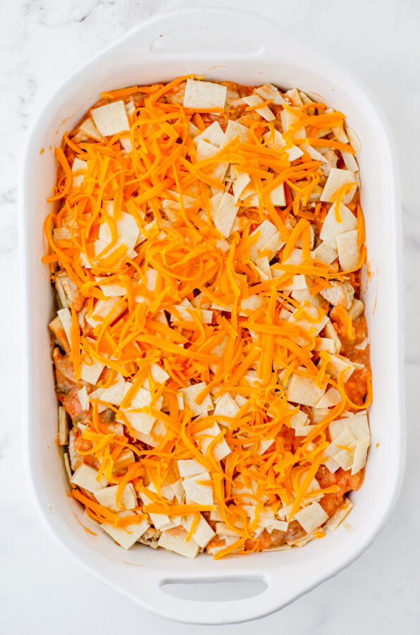 Shredded cheddar cheese on the top of layered Mexican Chicken Casserole