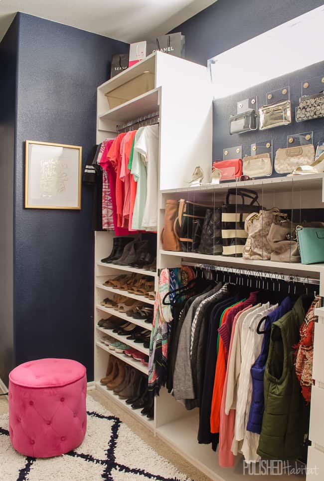 Closet organization system with hanging clothes rods, acrylic partitions for purses, and shelves for shoes