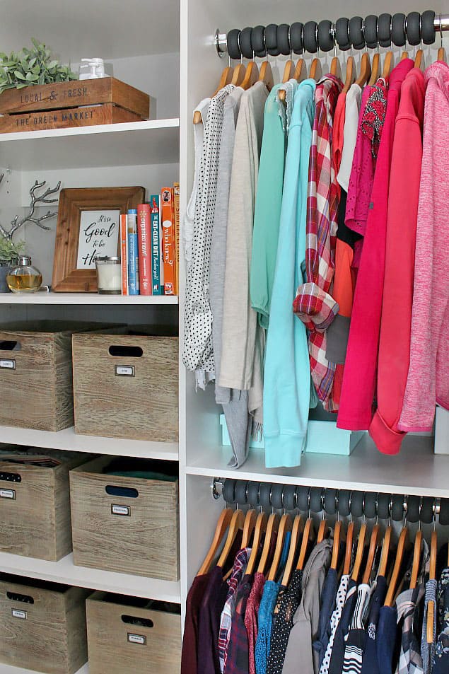 Hanging clothes beside a shelf unit with wooden crates