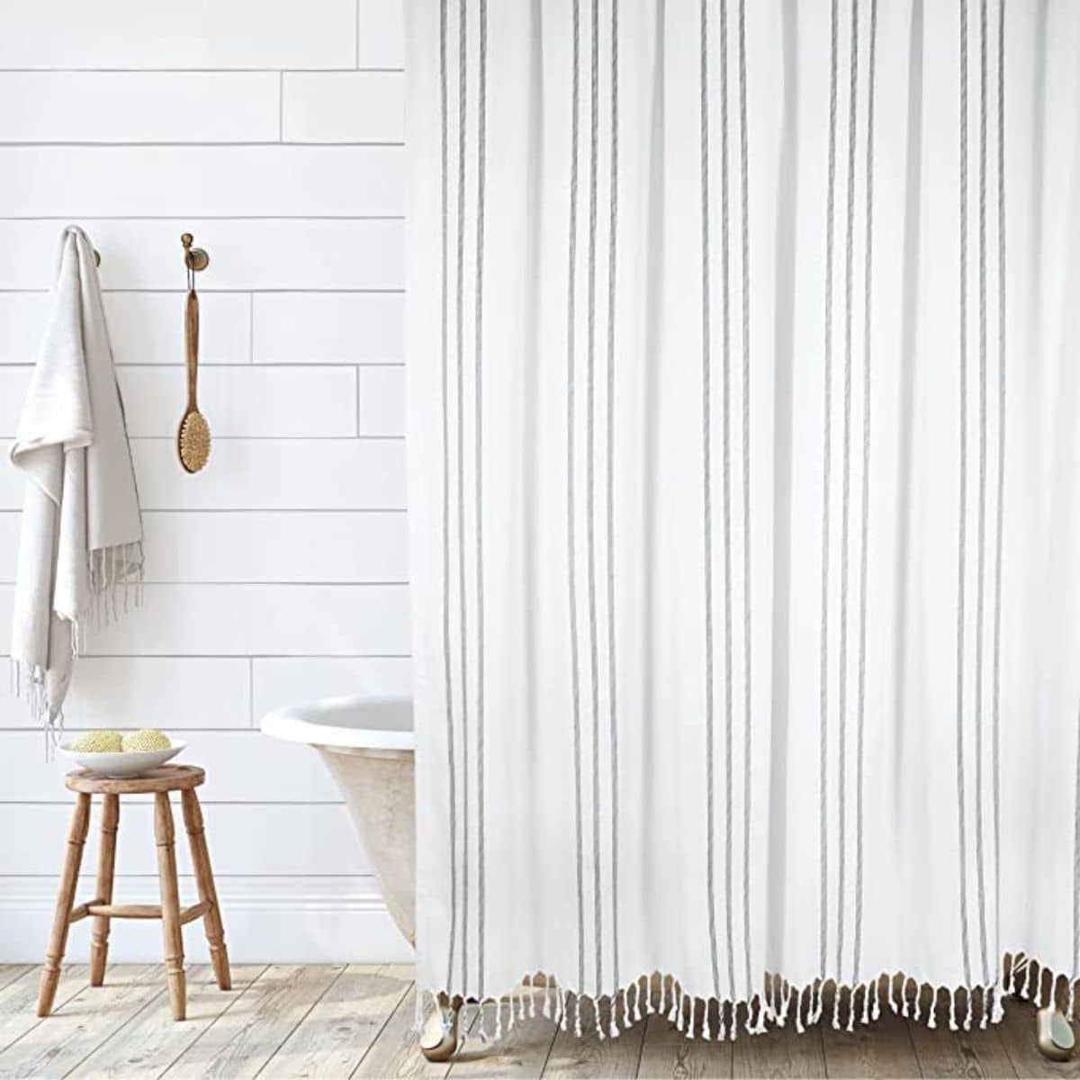 White bathroom with white shower curtain, tub and walls