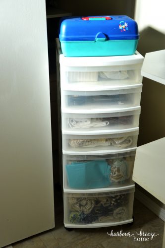 craft supplies like fabric organized in a plastic rolling drawer unit