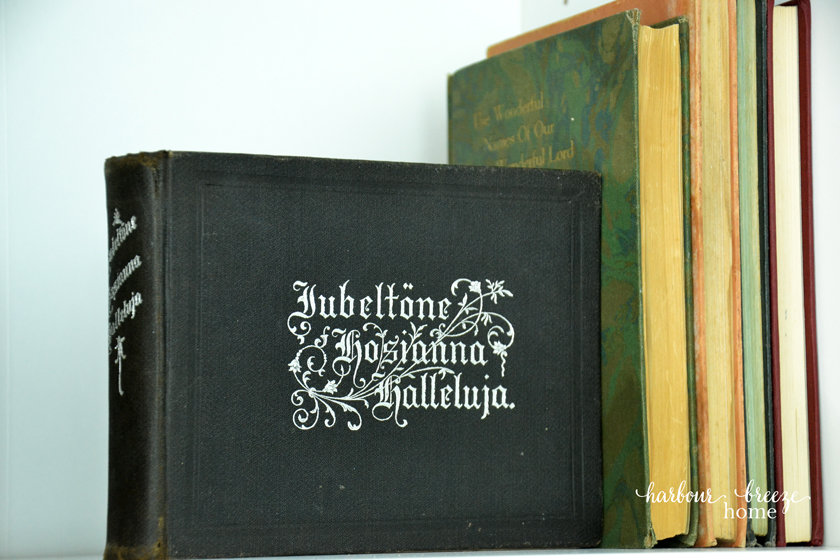 Old books stacked up as decor in a bookcase