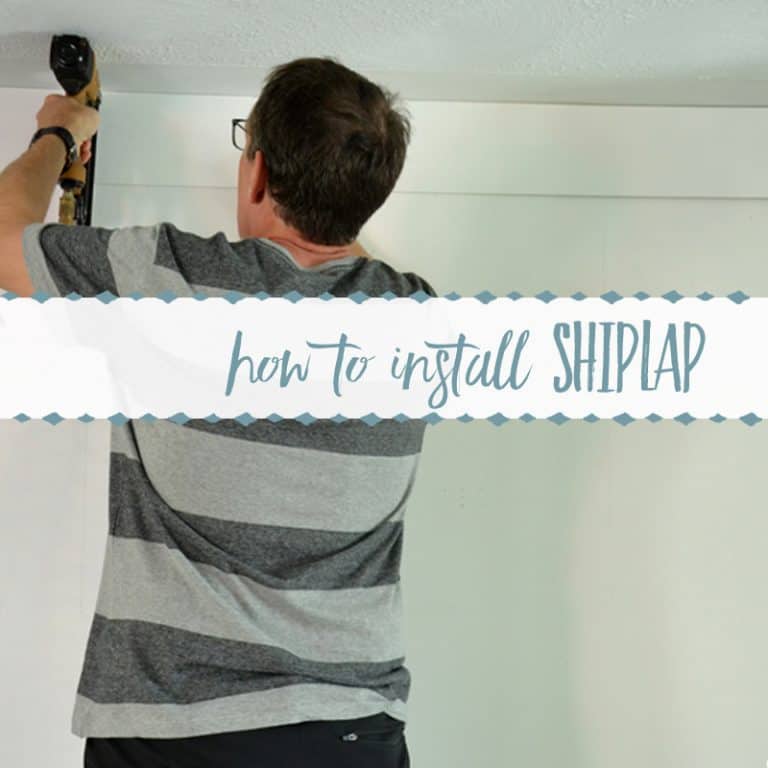 man nailing up shiplap on a wall