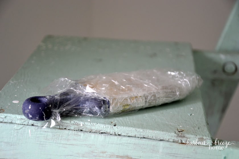 wrap a paint brush in plastic wrap so it won't dry out