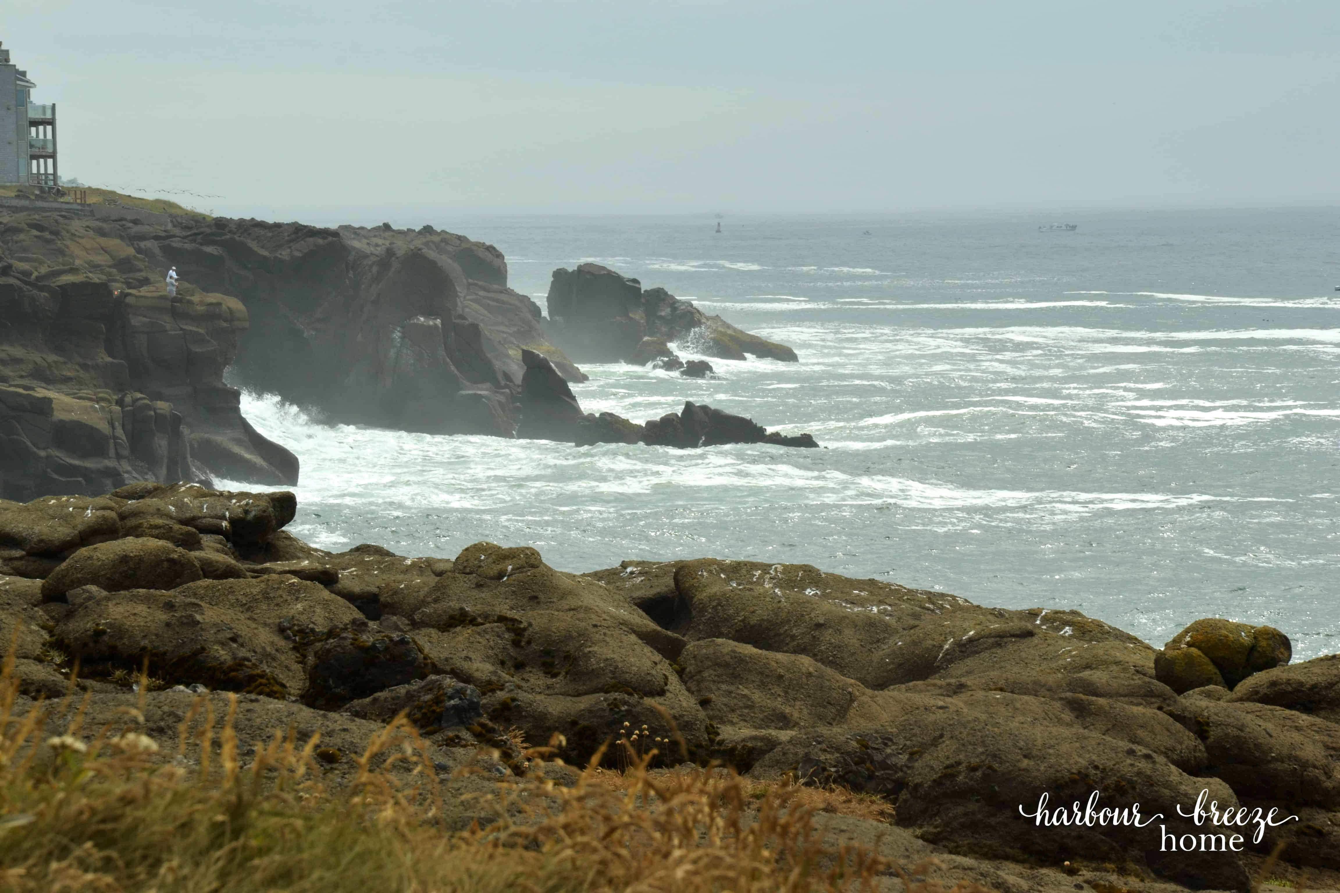 the ocean splashing against a rocky cliff