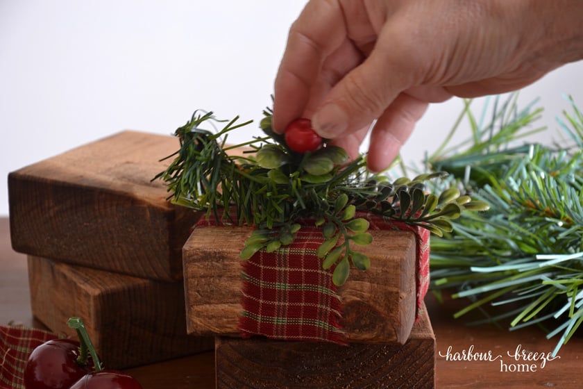 adding faux greenery to stained board