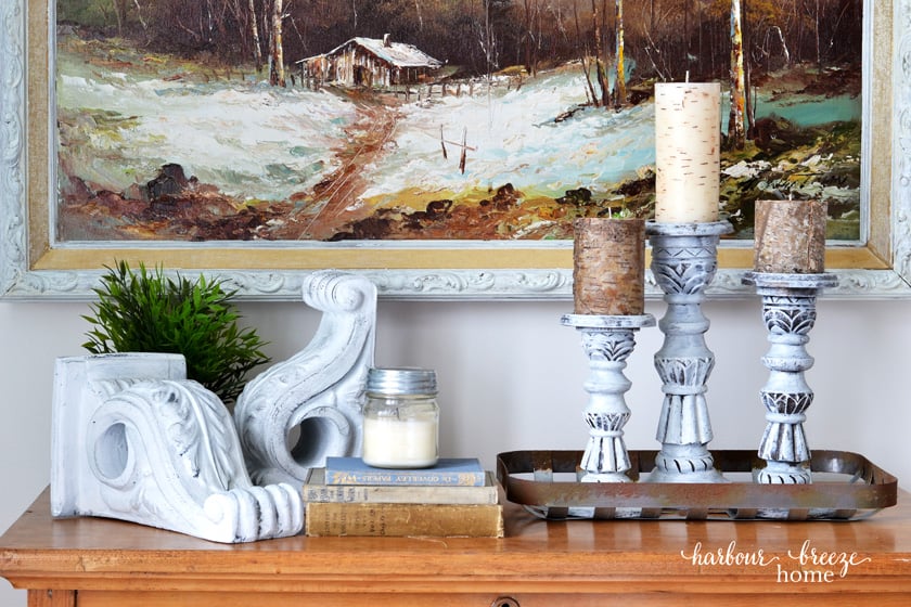 Farmhouse Style corbels on a table top with candles and vintage books