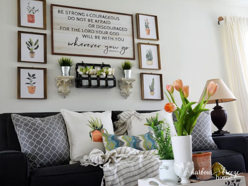 Gallery wall with free watercolor plant printables and pillows made with Avery iron on transfers