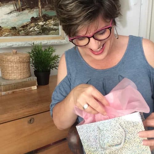 a woman looking in a gift bag