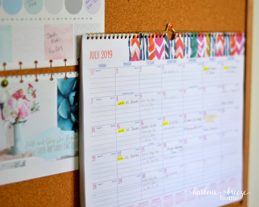 A large calendar hanging on a bulletin board.