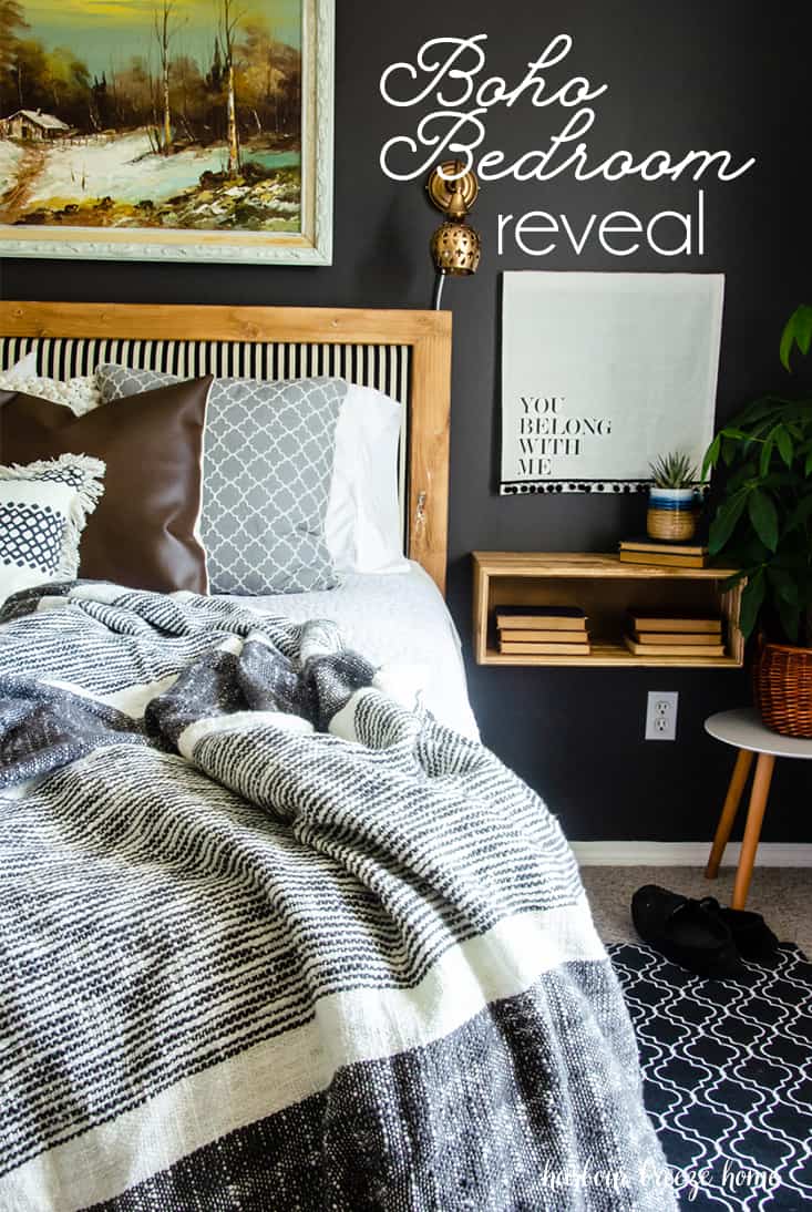 boho style bedroom showcaseing a bed with wooden headboard and striped upholstry, a wooden floating nightshelf, cozy throw blanket and a plant beside the nightstand.