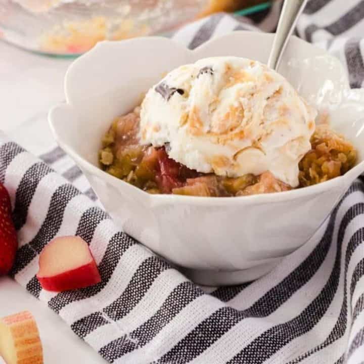 Bowl of the best rhubarb crisp with ice cream on the top