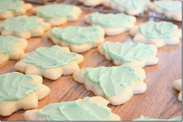iced rolled sugar cookie trees and stars on a counter