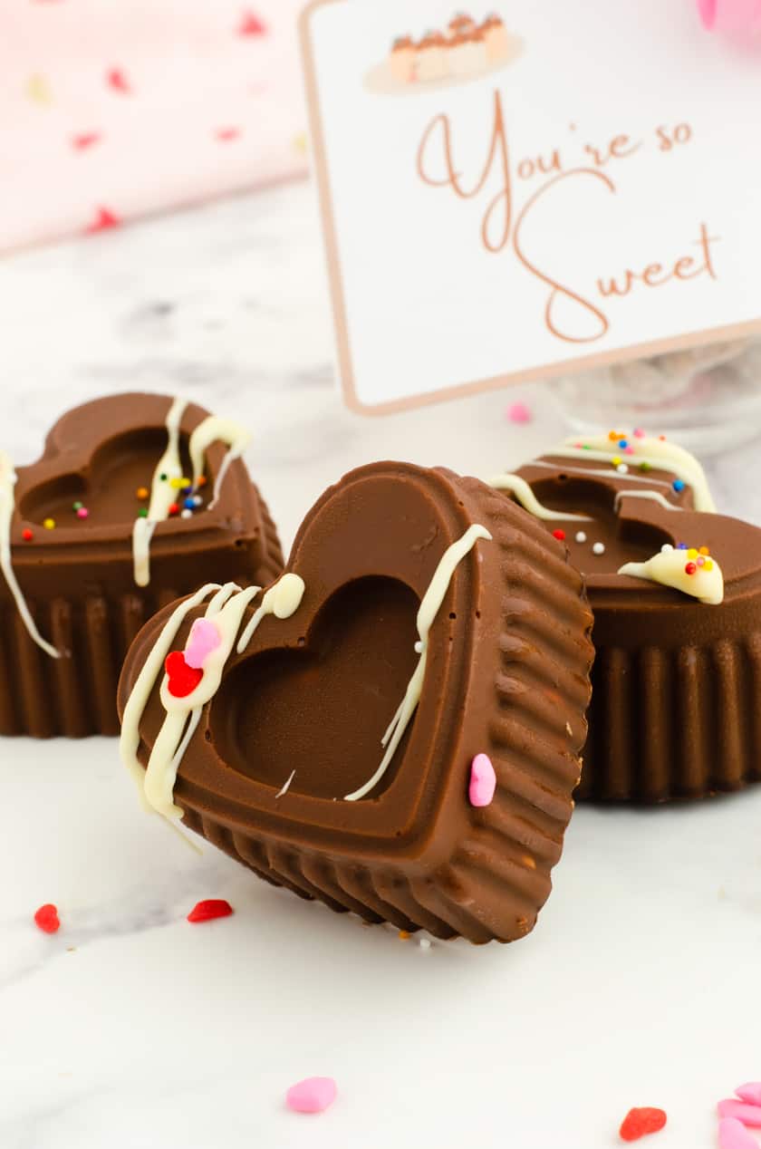 valentine hot cocoa bombs stacked up with a Valentine's Day card behind them