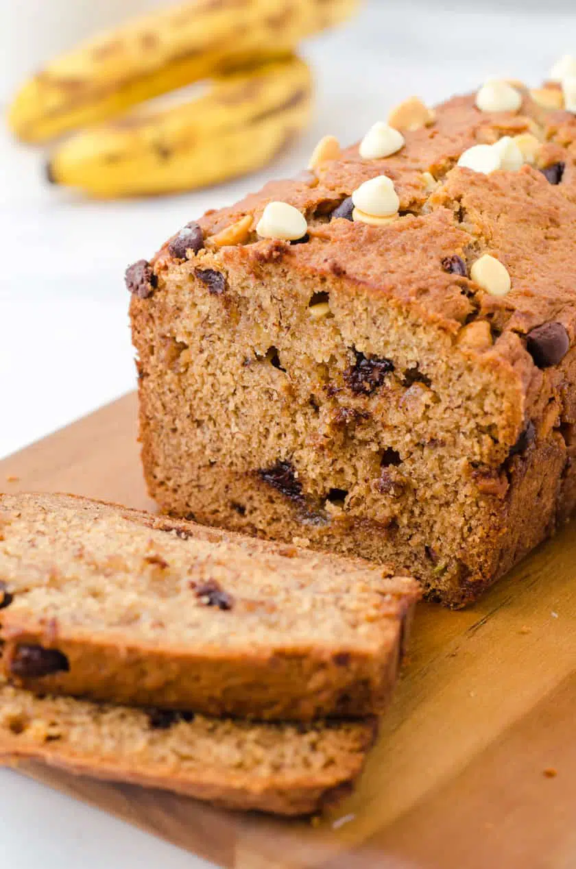 Sliced peanut butter chocolate chip banana bread on a cutting board.