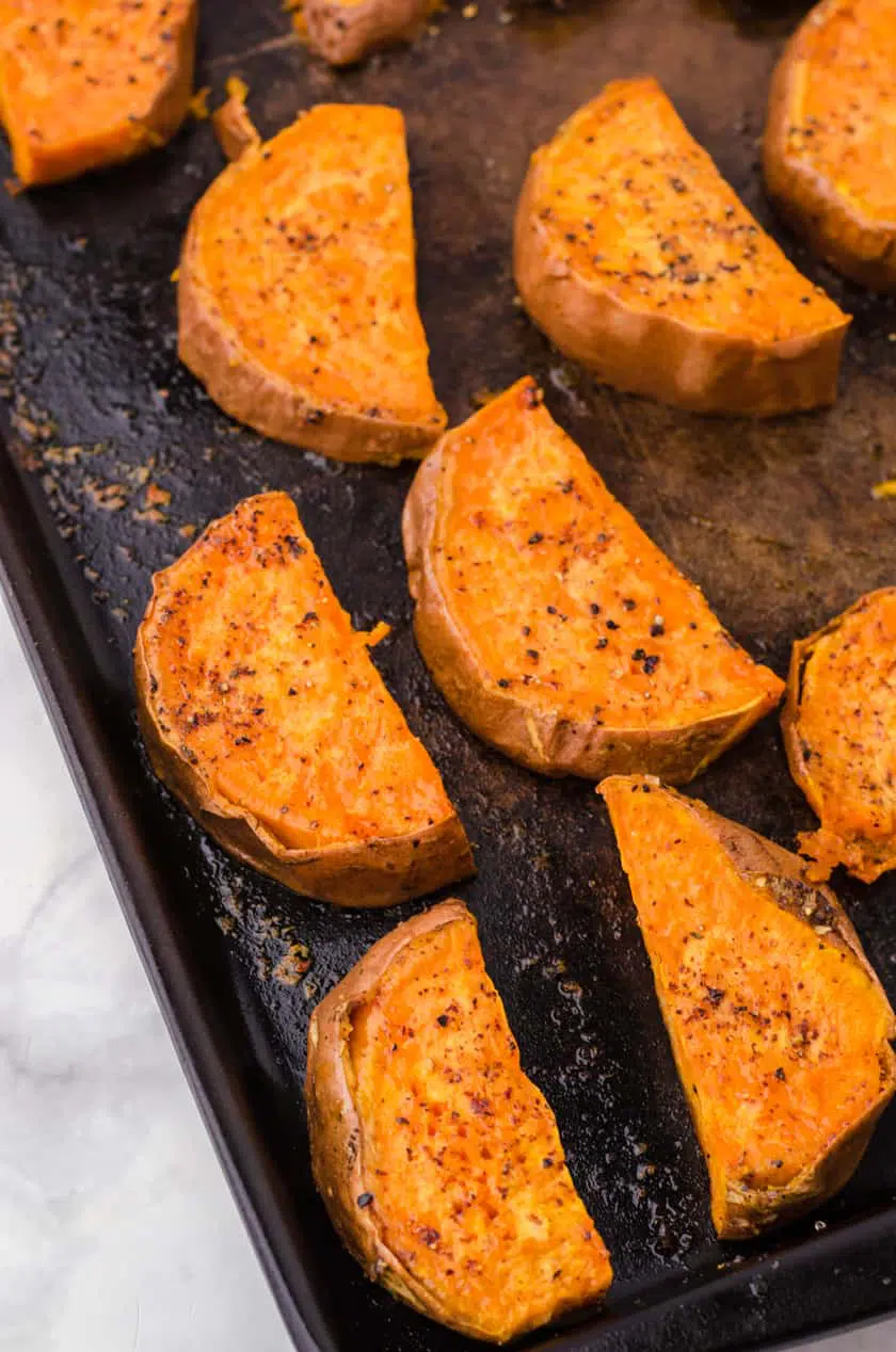 Oven baked sweet potatoes on a baking sheet