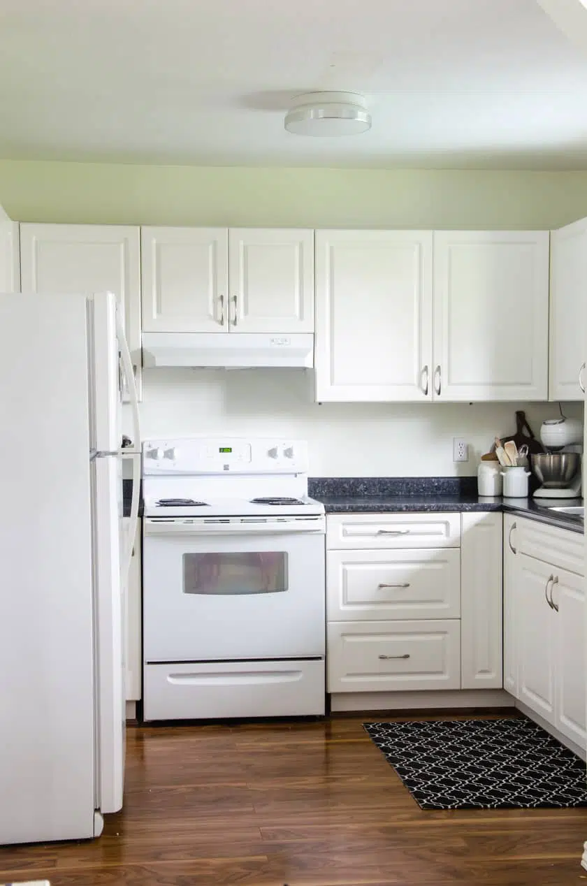 Small kitchen painted in Simply White paint color for a budget friendly small kitchen remodel upgrade.