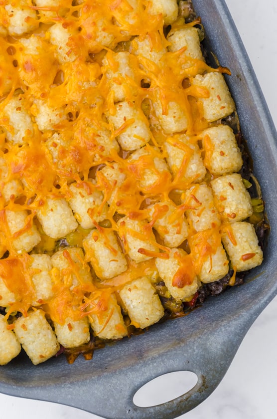 Close up of golden tater tots on the top of a tater tot casserole dish