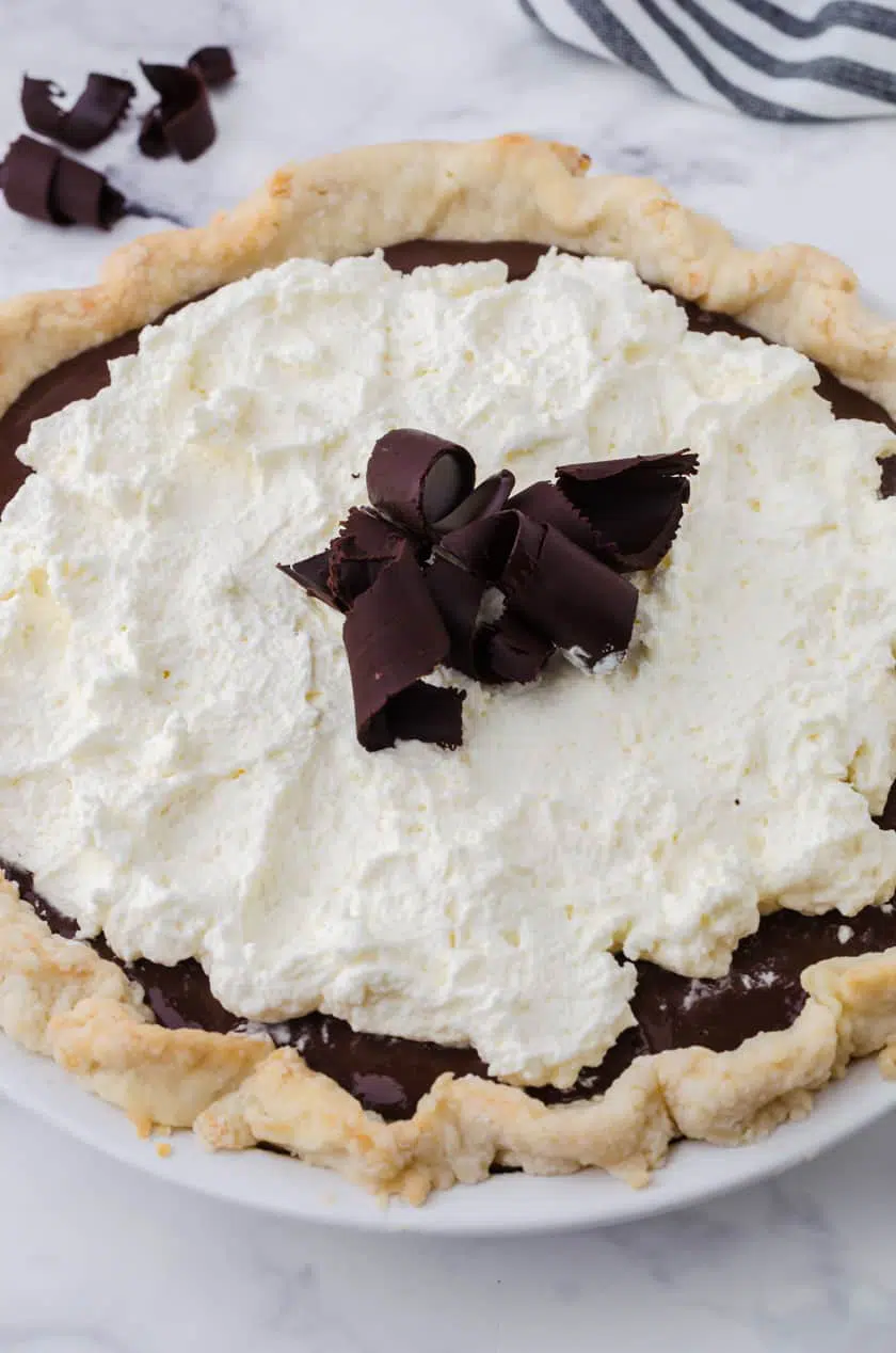 Close up of a whole chocolate cream pie.