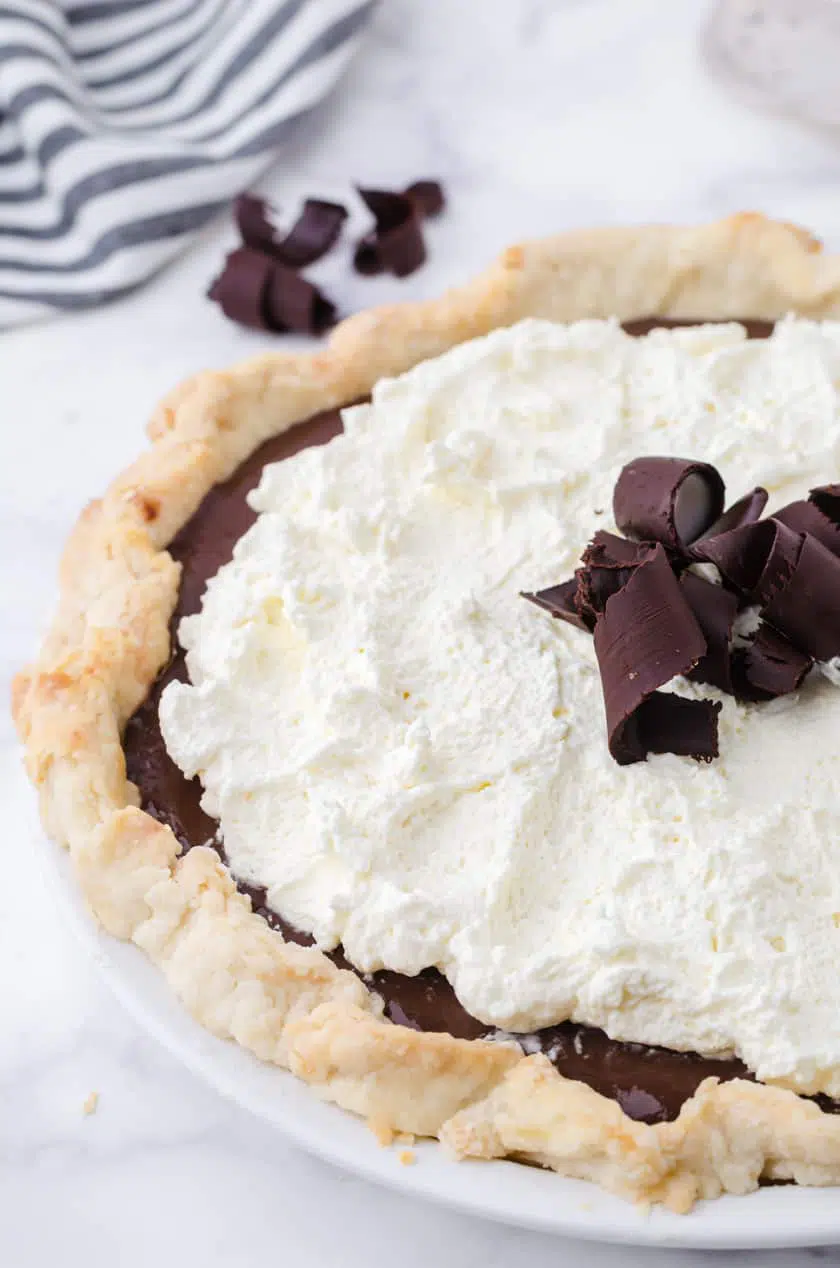 Chocolate pie with pudding filling and whipped cream topping