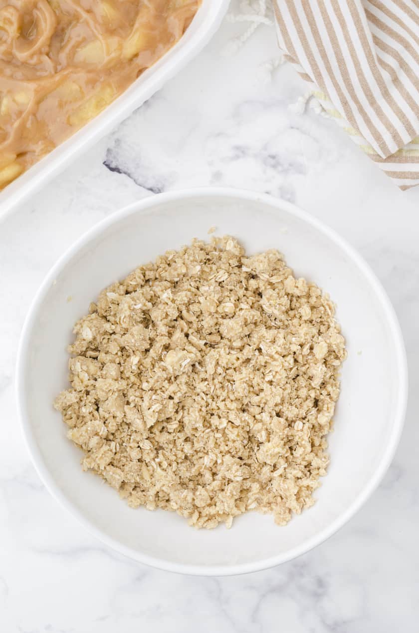 Homemade apple crisp struesal topping mixed together in a large mixing bowl.