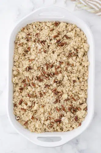 Apple crisp with apple pie filling in a 9x13 inch pan ready to be baked.