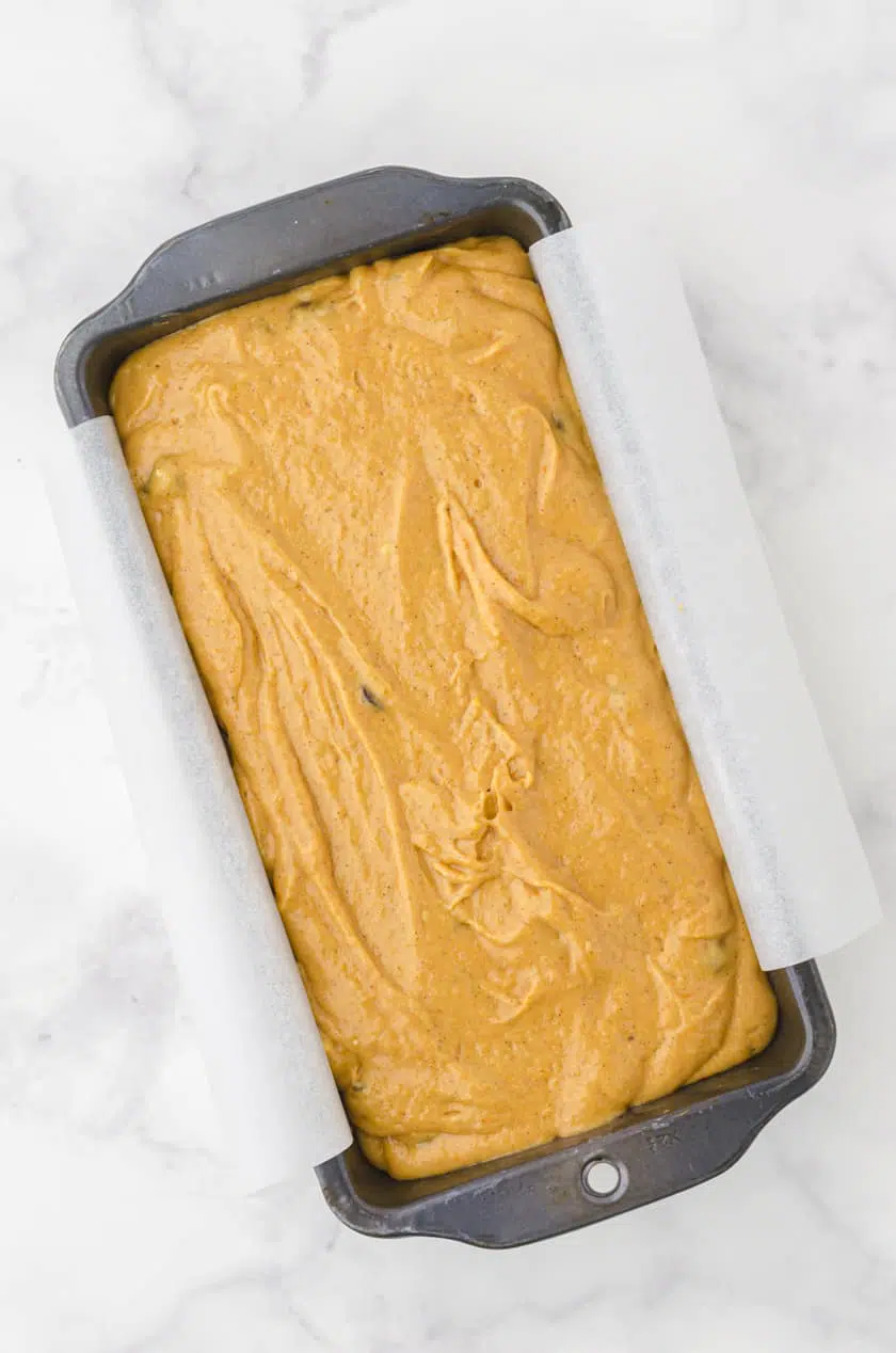 Cake mix and canned pumpkin pumpkin bread batter in a loaf pan ready to put in the oven.