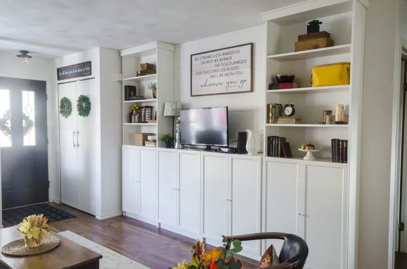 Ikea's Billy Bookcases decorated with Fall decor with neutral decor and splashes of sunflower yellow decor.