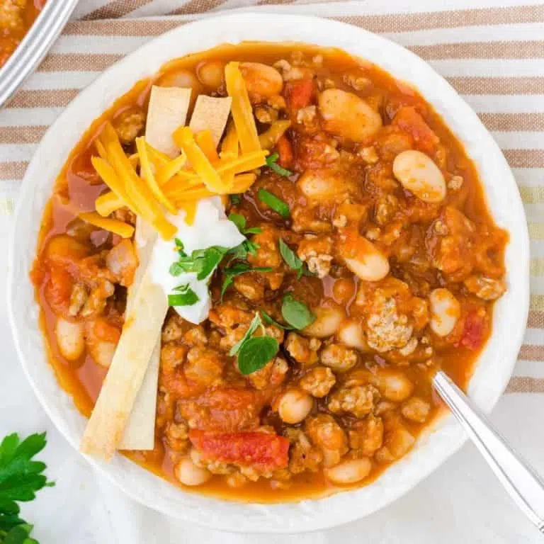 Turkey pumpkin chili in a bowl with toppings.