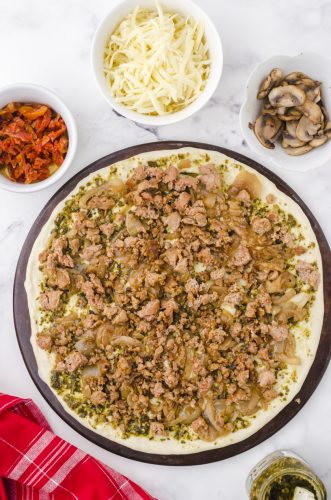 italian sausage layered on a homemade pizza