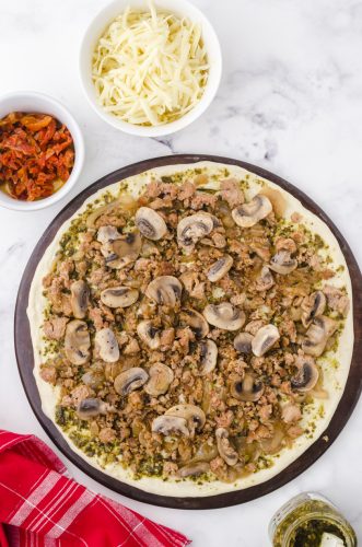sauted mushrooms layered on pesto pizza
