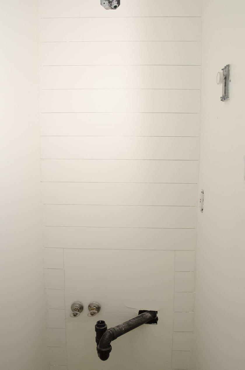 faux shiplap wall in a powdedr room where a vanity will go