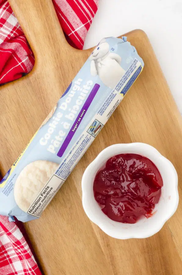 The two ingredients you'll need for this recipe - a purchased package of rolled sugar cookie dough and jam.