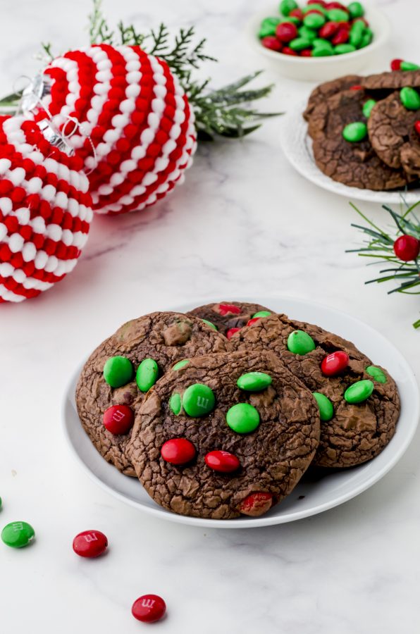 A small plate of Betty Crocker brownie mix cookies with red and green M&Ms on the top of them.